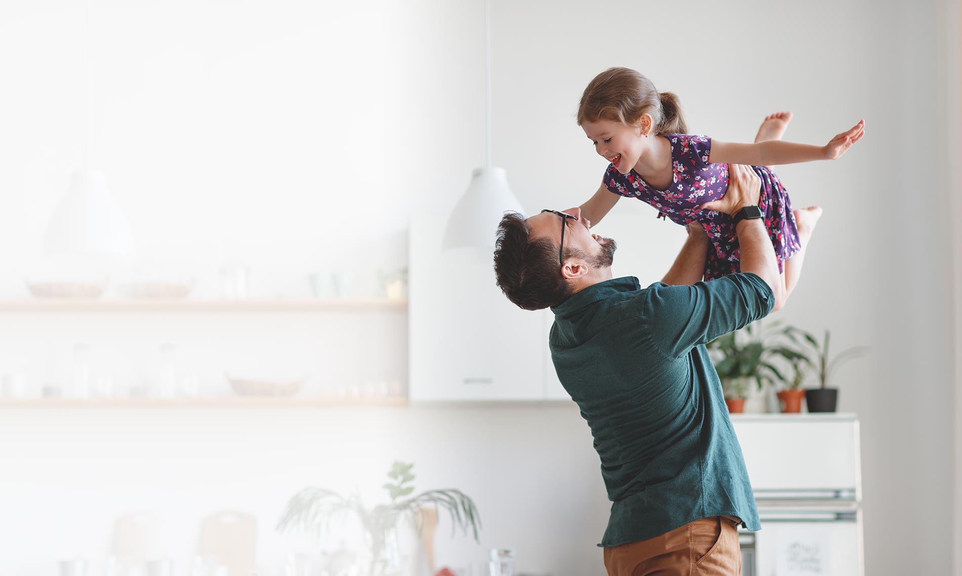 Father with glasses playing with her daughter